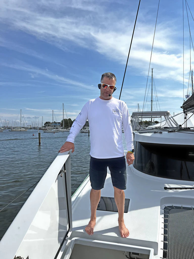 Man wearing 2Talk Bluetooth Headset on a boat. 